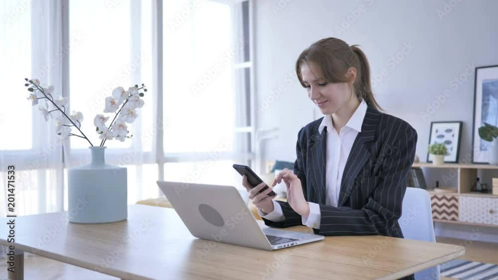 Woman Browsing on Smartphone at Work Woman Browsing on Smartphone at Work