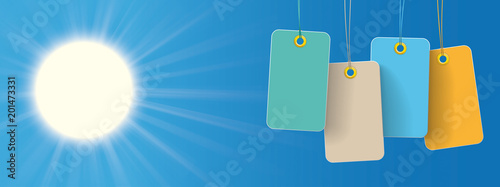 Bunte Preisschilder vor einem blauen Himmel mit strahlenden Sonne