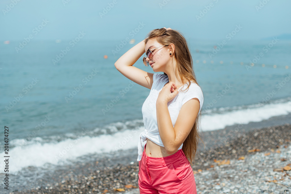 Fashion Portrait of Beautiful Girl. Posing on Beach at Europe. Fashion Portrait of Beautiful Girl. Posing on Beach at Europe.
