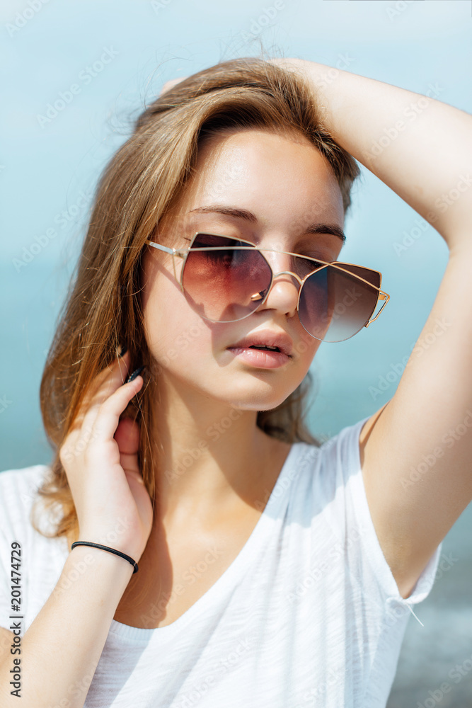 Fashion Portrait of Beautiful Girl. Posing on Beach at Europe. Fashion Portrait of Beautiful Girl. Posing on Beach at Europe.