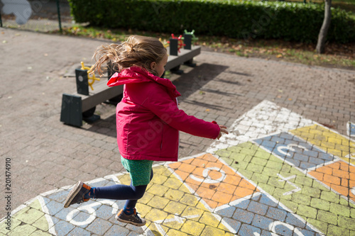 Girl playing hopscotch