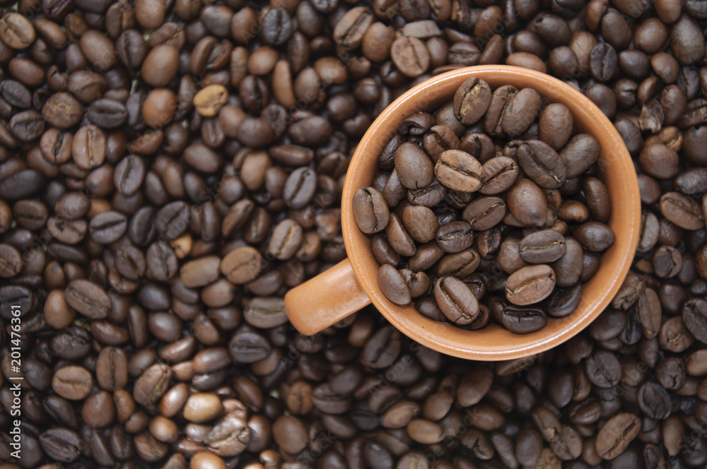 Cup full of coffee beans with copy space Cup full of coffee beans with copy space