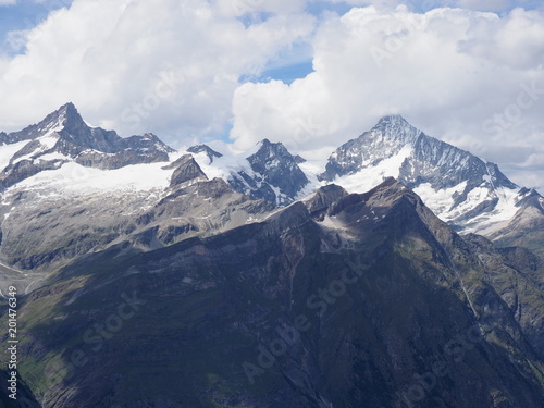 Panorama of alpine mountains range in swiss Alps seen from Gornergrat at SWITZERLAND, cloudy sky in 2017 warm sunny summer day on July. © Jakub Korczyk