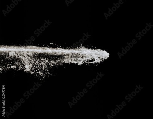 powerful jet of water with white foam isolated on black background. champagne splashes © pal1983