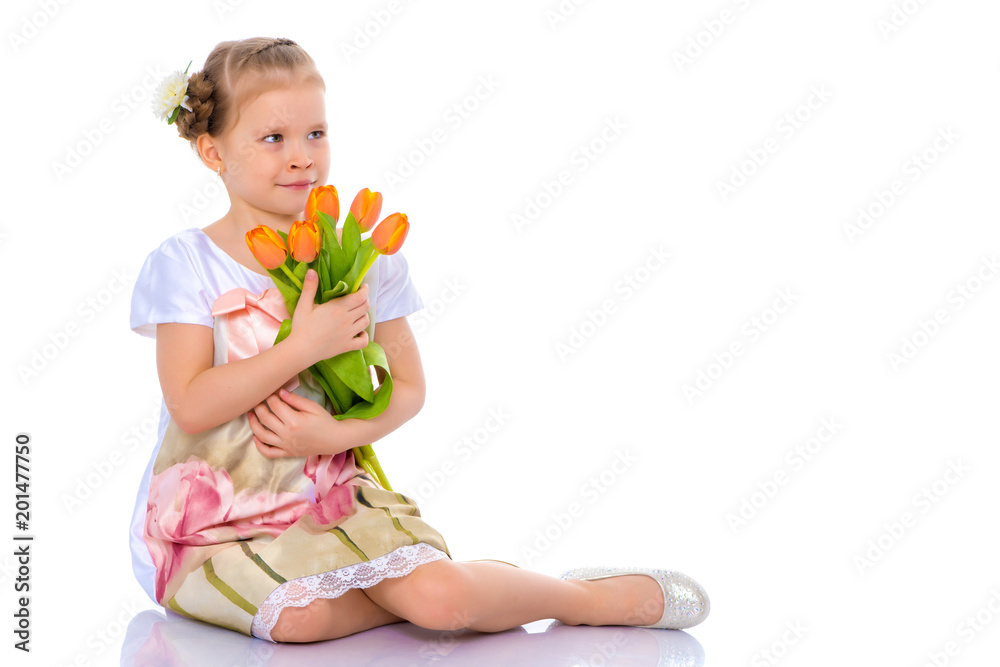 Little girl with bouquet of flowers sits on the floor. Little girl with bouquet of flowers sits on the floor.