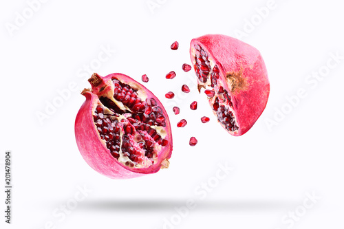 Slika na platnu Pomegranate in flight burst on a white background, isolated