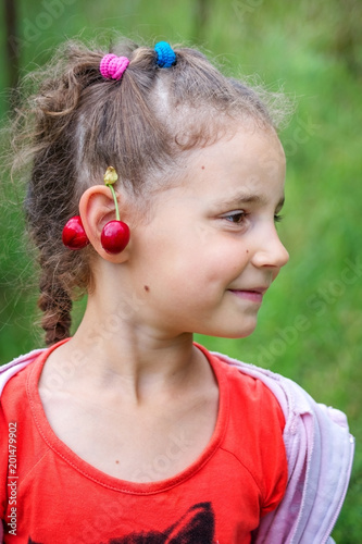 Baby girl with cherry earrings.