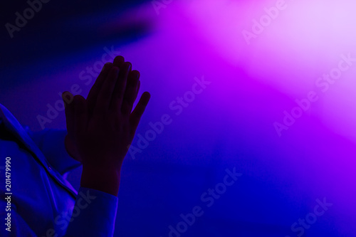 Fototapeta Naklejka Na Ścianę i Meble -  boy applauds in a room with blue and pink lighting