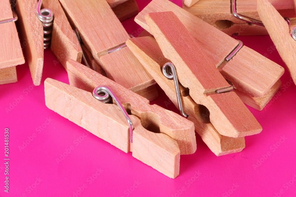 a heap of wooden clothespins are lying in the pink studio a heap of wooden clothespins are lying in the pink studio
