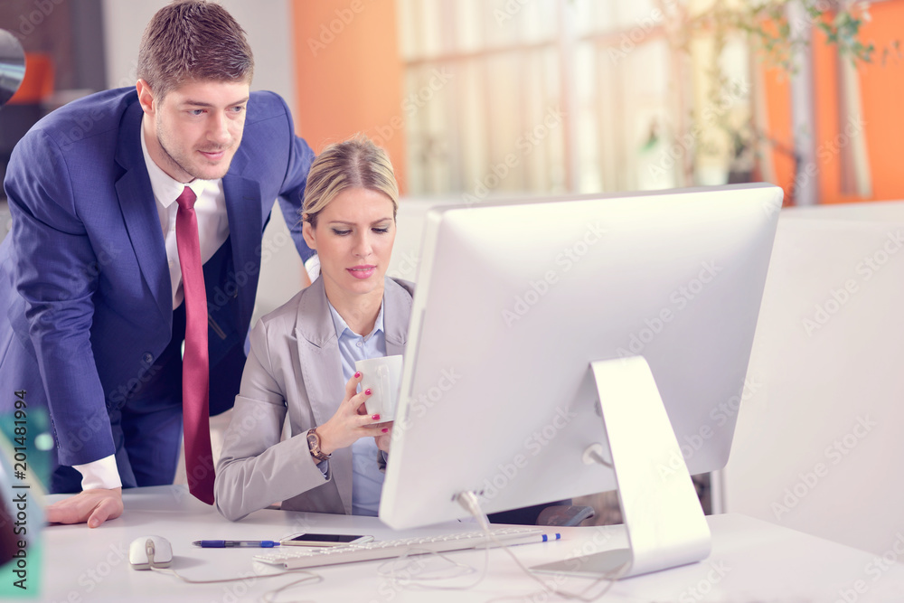 Business couple working together on project at modern startup office Business couple working together on project at modern startup office