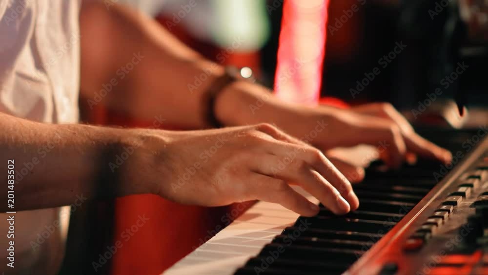 The hands of a musician closeup playing the synthesizer on a rock concert. The hands of a musician closeup playing the synthesizer on a rock concert.