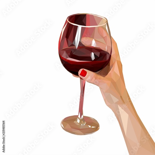 a glass of red wine in a beautiful female hand 