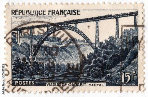 Leeds, England - April 20 2018: an old blue french postage stamp with an image of Garabit Viaduct railway bridge photo