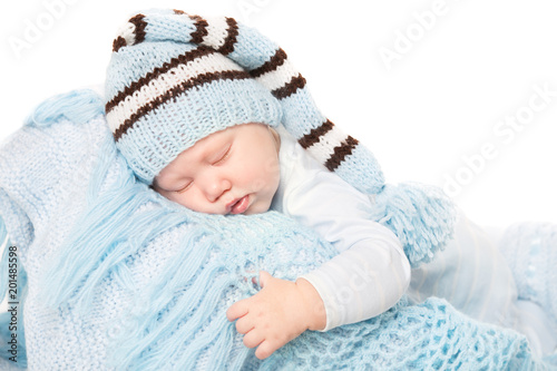 Newborn Baby Boy Sleep in Blue Hat, New Born Child Sleeping on Knitted Woolen Blanket over White Background, Kid Six Months Old © inarik