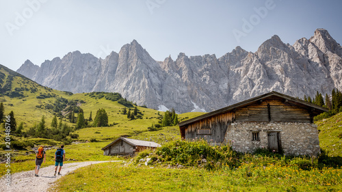 hiking in alpenpark karwendel austria with mountainscape background backpackers and house