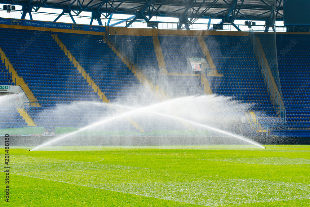 Irrigation turf. Sprinkler watering football field. System working on