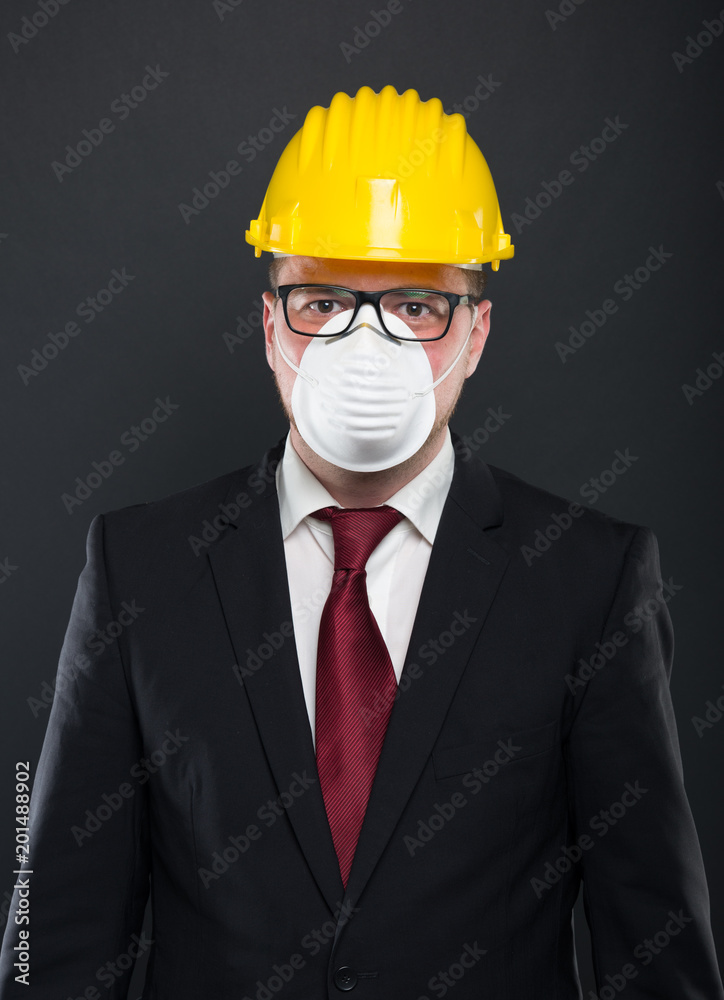 Portrait of business man wearing hardhat and mask . Portrait of business man wearing hardhat and mask .
