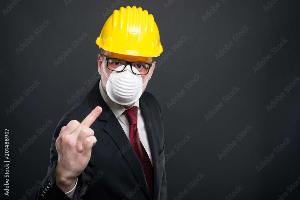 Business man wearing hardhat and mask showing obscene gesture. Business man wearing hardhat and mask showing obscene gesture.