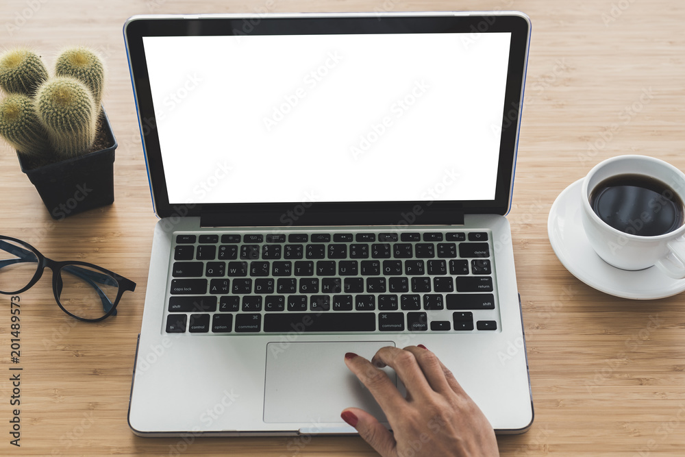 Woman hand with computer laptop on wood table. Woman hand with computer laptop on wood table.