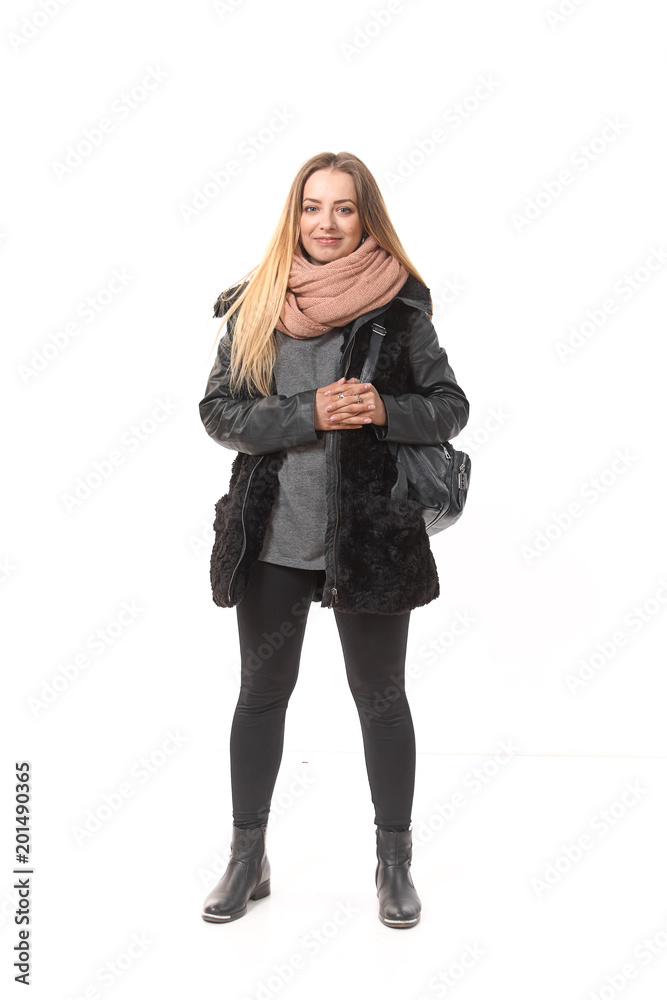A girl in demi-season clothes with a full-length bag on a white background. A girl in demi-season clothes with a full-length bag on a white background.
