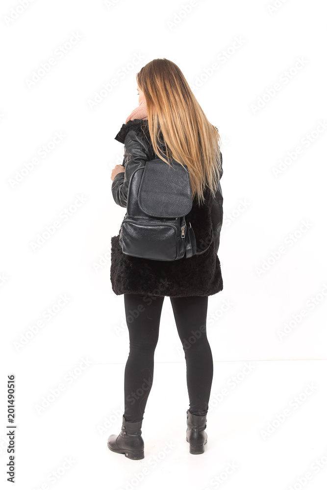 A girl in demi-season clothes with a full-length bag on a white background. A girl in demi-season clothes with a full-length bag on a white background.