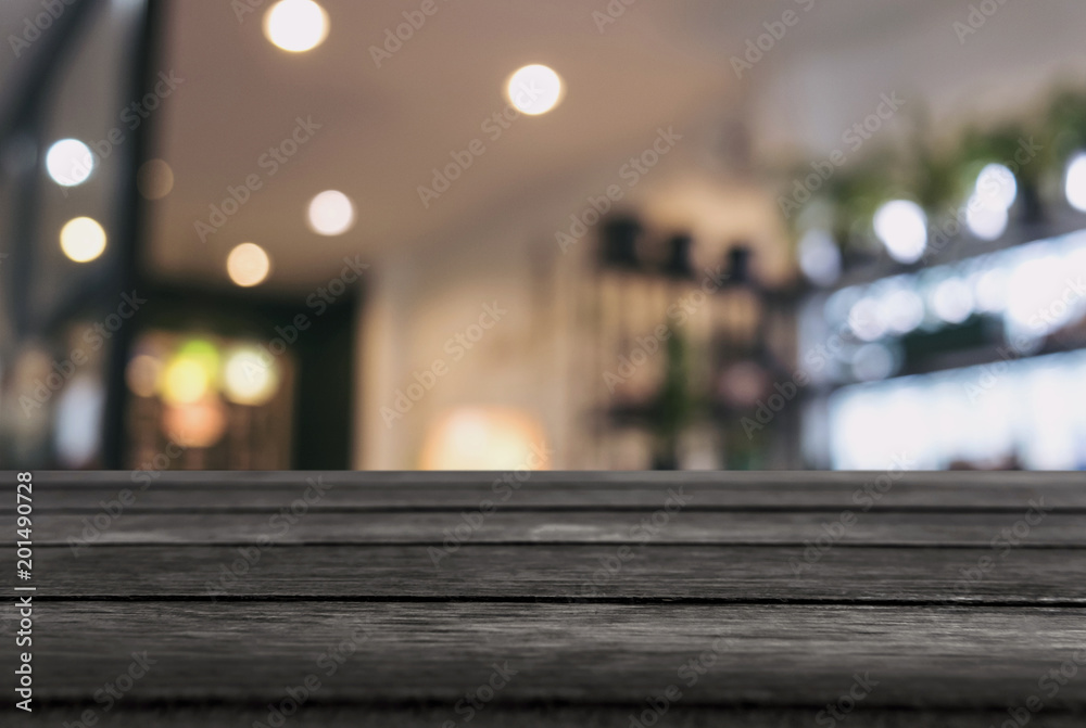 Empty wooden table and blurred background of abstract in front of restaurant or coffee shop for display of product or for montage Empty wooden table and blurred background of abstract in front of restaurant or coffee shop for display of product or for montage