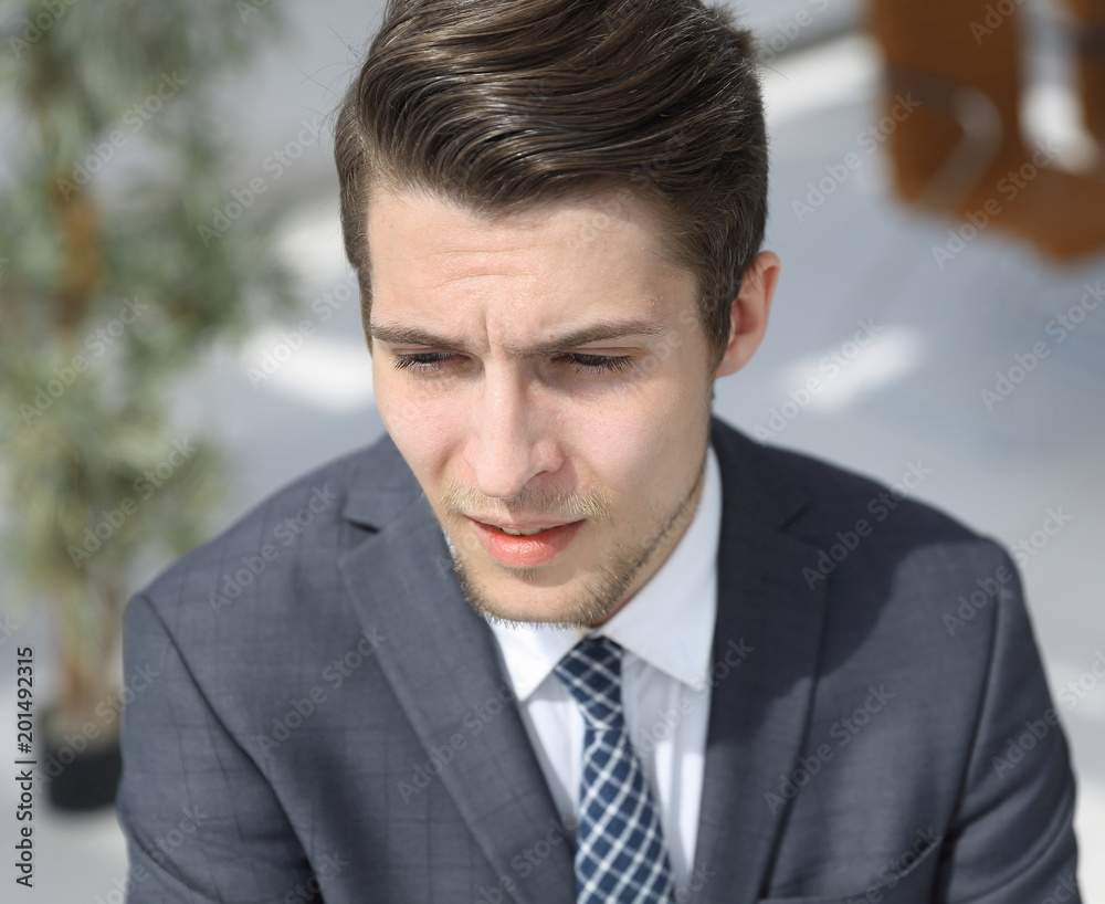closeup.the face of a successful young man closeup.the face of a successful young man