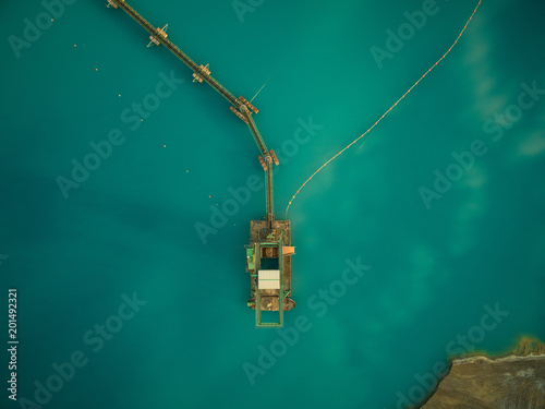 aerial view of sand dredge in blue lake photo