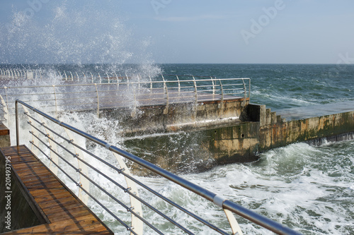 Splashing sea water on spring sunny windy stormy day. Horizontal color photography. © Andrii Oleksiienko