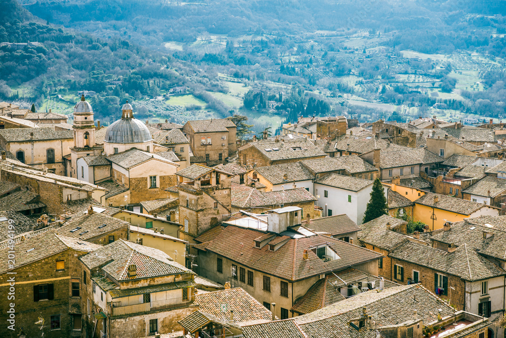 aerial view of buildings and hills with trees in Orvieto, Rome suburb, Italy