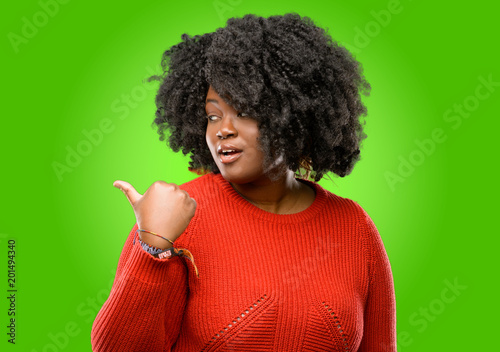 Beautiful african woman pointing away side with his finger