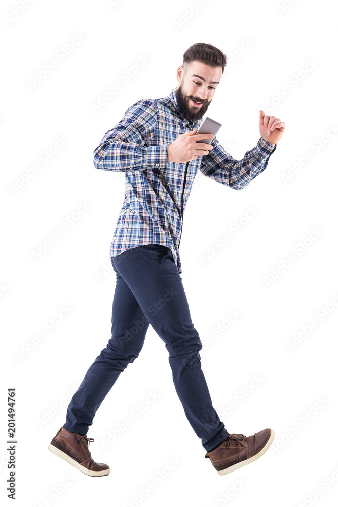 Excited business man looking on the cellphone running in hurry. Side view. Full body isolated on white background. Excited business man looking on the cellphone running in hurry. Side view. Full body isolated on white background.