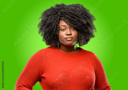 Beautiful african woman confident and happy with a big natural smile looking at camera