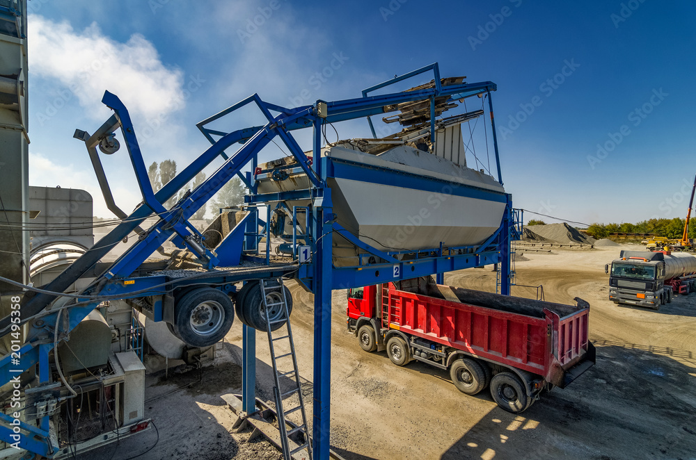 Mobile asphalt-concrete plant. Loading the red dumper. Mobile asphalt-concrete plant. Loading the red dumper.