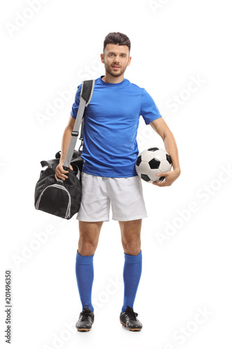 Soccer player with a sports bag and a football