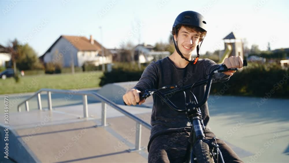 BMX rider hold up the bicycle with smile on face 4K BMX rider hold up the bicycle with smile on face 4K