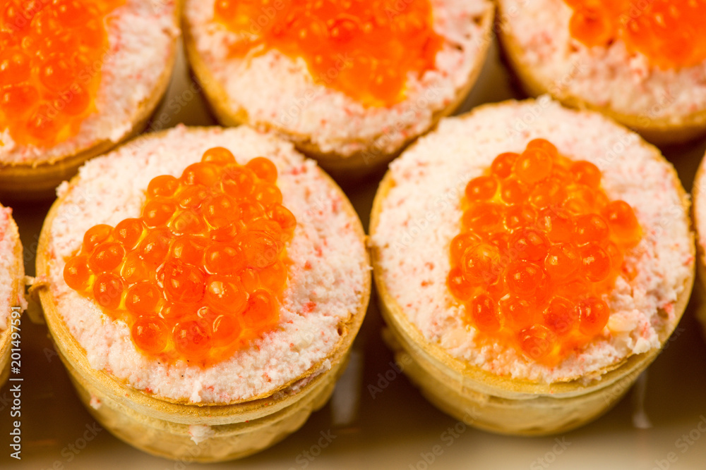 Tartlets with cheese and red caviar. Selective focus. Copy space