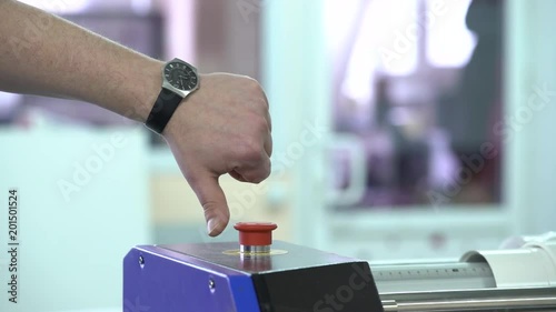 The worker presses the button and shows a thumb down.