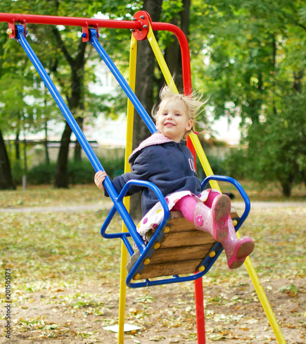 child riding on a swing