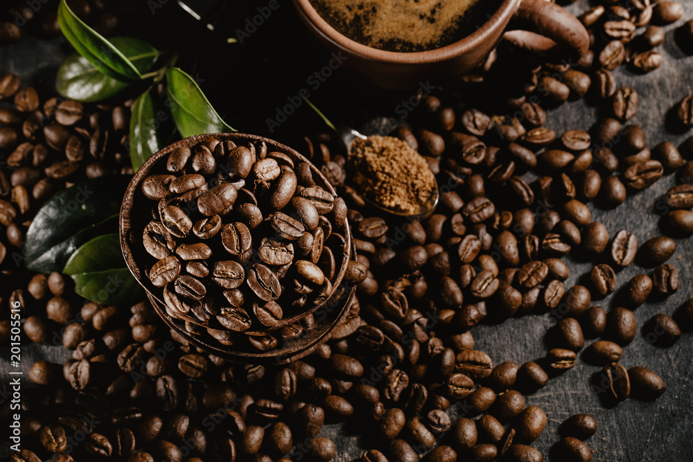 Fototapeta premium Cup of brewed coffee among aromatic beans