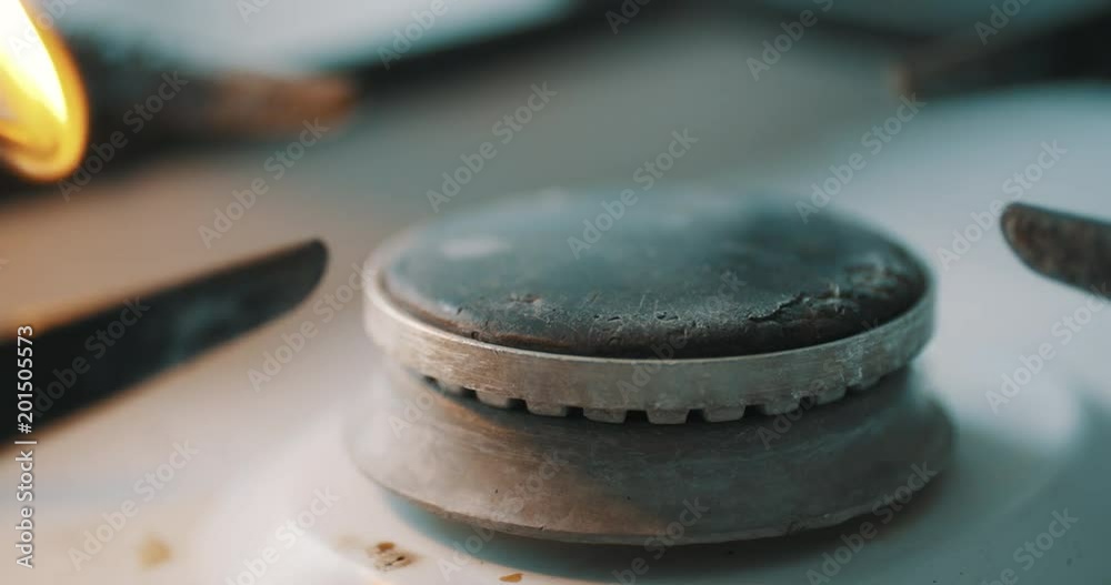 Stove burner igniting into blue cooking flame in slow motion Stove burner igniting into blue cooking flame in slow motion