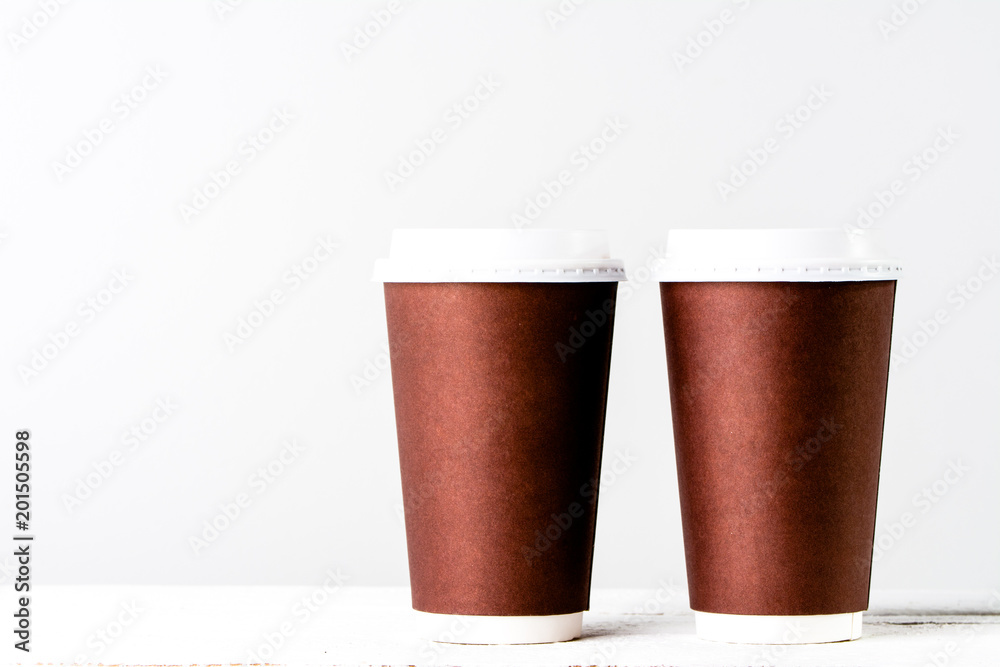 Disposable paper cup to coffee take away. Brown cups with lid for safety drinking. Disposable paper cup to coffee take away. Brown cups with lid for safety drinking.