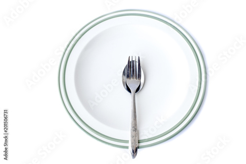Spoon and Fork on plate, isolated on white background