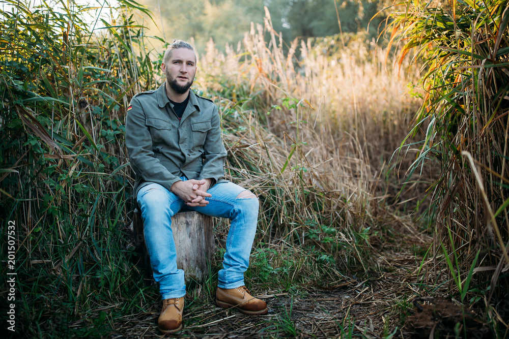 Portrait of a young guy with a beard in nature. Portrait of a young guy with a beard in nature.
