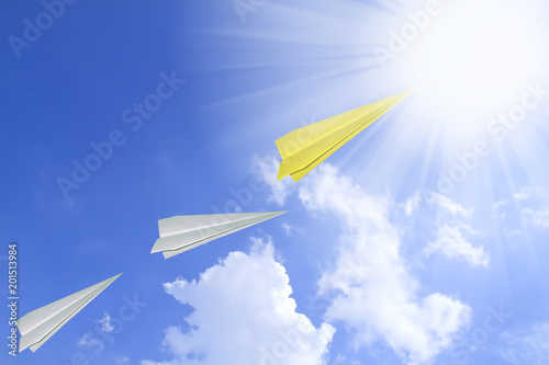 Concept of leadership as paper plane flying to the rising sun