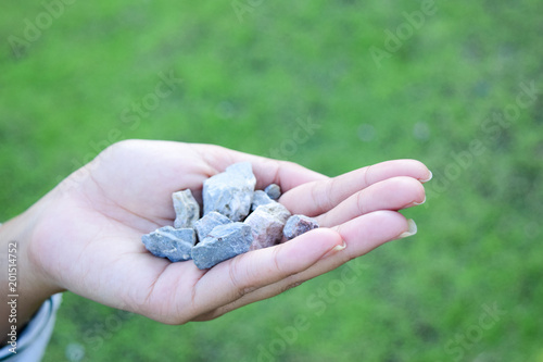 Woman hands holding small stones in hands