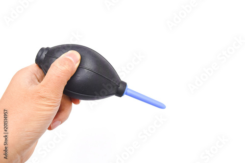 hand holding dust blower or air pump from dust