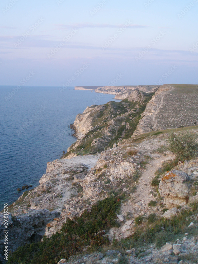 Stony uneven cliff near the sea