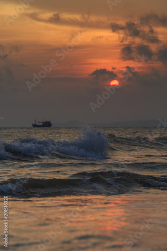 fishing boat to the sea at sunset