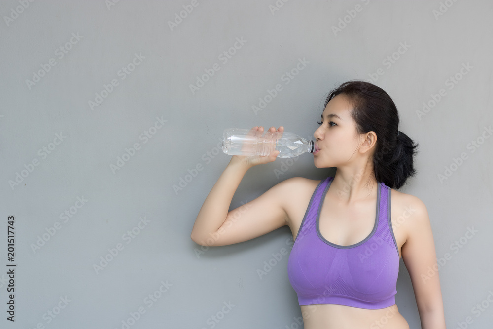 Young woman are drinking water after exercise. Young woman are drinking water after exercise.